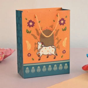 sacred cow gift carry bag in traditional orange and teal for return gifts
